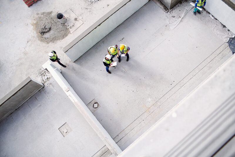 Construction team reviewing plans on a building site